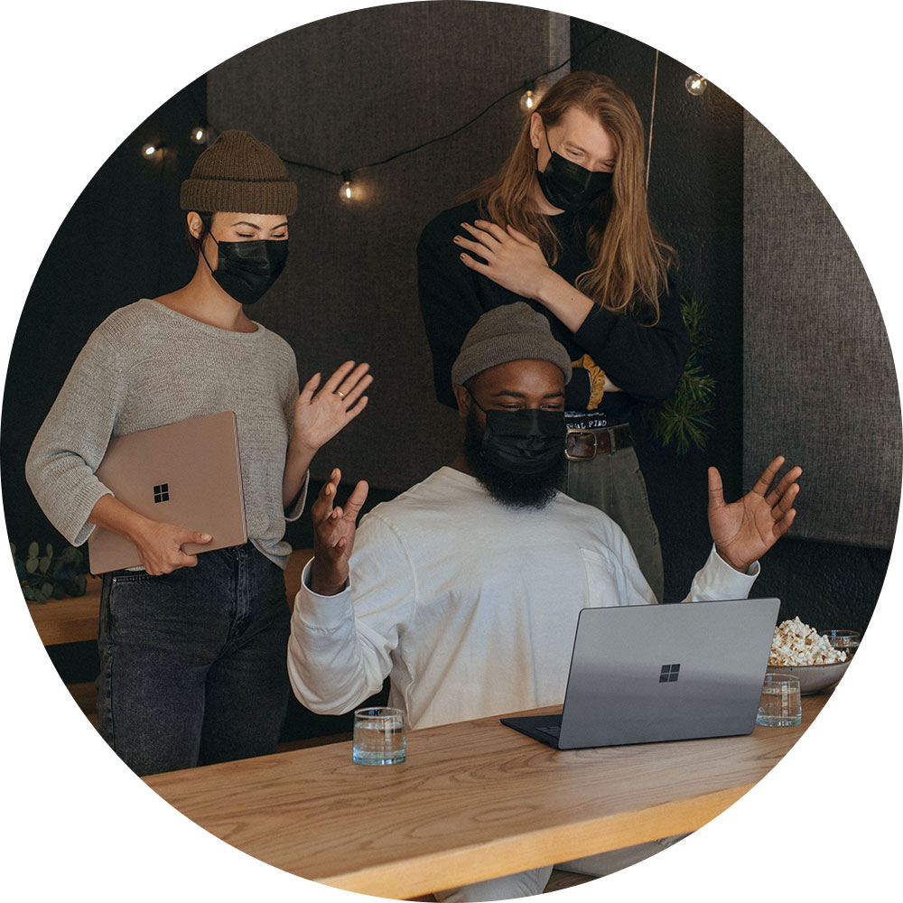 Three-people-happy-with-Microsoft-laptop